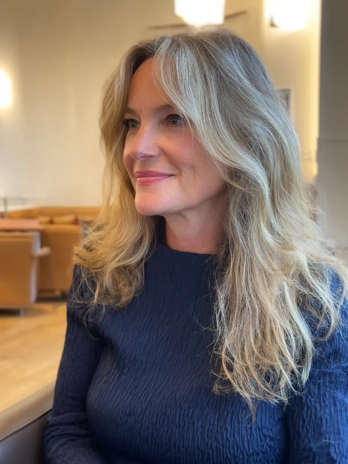 Long Sandy Blonde Layers with Soft Curtain Bangs